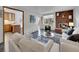 Living room with fireplace and view into updated kitchen at 2665 S Sheridan Ct, Lakewood, CO 80227
