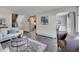Spacious living room with hardwood floors and views into kitchen at 2665 S Sheridan Ct, Lakewood, CO 80227