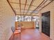 Covered patio with brick flooring and two orange chairs at 2665 S Sheridan Ct, Lakewood, CO 80227