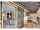 Private patio with sliding glass door access, safety bars, and view into a cozy living area at 2665 S Sheridan Ct, Lakewood, CO 80227