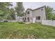 Large backyard with a manicured lawn, patio set and white fence at 6526 S Killarney Ct, Aurora, CO 80016