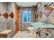 Cozy bathroom features unique tile, a glass sink and vanity, and a framed window with colorful drapes at 6526 S Killarney Ct, Aurora, CO 80016