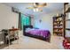 Comfortable bedroom with neutral carpet, a small desk, and a built-in bookshelf with toys at 6526 S Killarney Ct, Aurora, CO 80016