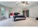 Large bedroom features plush carpeting, a ceiling fan, neutral paint, and a large window at 6526 S Killarney Ct, Aurora, CO 80016