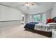 Spacious main bedroom features a ceiling fan and a large bay window with views of mature trees at 6526 S Killarney Ct, Aurora, CO 80016