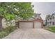 Two-story home with brick facade and spacious three-car garage and concrete driveway at 6526 S Killarney Ct, Aurora, CO 80016