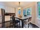 Bright kitchen features a granite-topped breakfast table and sliding doors to the outdoor living space at 6526 S Killarney Ct, Aurora, CO 80016