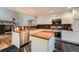Well-lit kitchen featuring white cabinets, a stainless-steel dishwasher and granite countertops at 6526 S Killarney Ct, Aurora, CO 80016