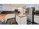 Updated kitchen with white cabinets, stainless steel appliances, and center island at 6526 S Killarney Ct, Aurora, CO 80016