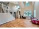 Sun-filled open living space with soaring ceiling, hardwood floors and large windows at 6526 S Killarney Ct, Aurora, CO 80016