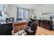 Home office with hardwood floors, a large window, and two toned walls at 6526 S Killarney Ct, Aurora, CO 80016