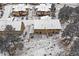 A bird's eye view of the property showcasing the backyard with a patio, furniture, and surrounding trees at 726 Dreamcatcher Ln, Evergreen, CO 80439