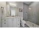 Modern bathroom boasts marble countertop, white cabinets, and a glass-enclosed shower at 726 Dreamcatcher Ln, Evergreen, CO 80439