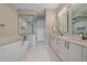Elegant bathroom featuring a soaking tub, walk-in shower, dual vanities, and modern fixtures at 726 Dreamcatcher Ln, Evergreen, CO 80439