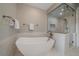 Bright, modern bathroom featuring a soaking tub, a glass-enclosed shower, and sleek fixtures at 726 Dreamcatcher Ln, Evergreen, CO 80439