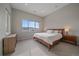 Bright bedroom with a large window, a wooden bed frame, and two wooden nightstands at 726 Dreamcatcher Ln, Evergreen, CO 80439