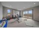 Spacious bonus room with natural light, a sliding door to a deck, and ample space for workout equipment at 726 Dreamcatcher Ln, Evergreen, CO 80439