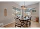 Inviting dining area with large window, wood table, and modern light fixture at 726 Dreamcatcher Ln, Evergreen, CO 80439