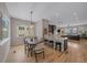 Charming dining area features a modern light fixture, hardwood floors, and flows seamlessly into the kitchen and living room at 726 Dreamcatcher Ln, Evergreen, CO 80439