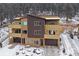 A modern exterior showing a well landscaped front yard and a driveway leading up to the two car garage at 726 Dreamcatcher Ln, Evergreen, CO 80439