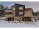 Modern townhouses with covered decks and a two-car garage in a snowy mountain neighborhood at 726 Dreamcatcher Ln, Evergreen, CO 80439