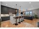 Modern kitchen featuring an island with seating, hardwood floors, and upscale finishes at 726 Dreamcatcher Ln, Evergreen, CO 80439