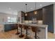 Kitchen island with leather stools and hardwood floors and cabinetry at 726 Dreamcatcher Ln, Evergreen, CO 80439