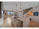Open kitchen features a large island with marble countertops and stainless steel appliances, flowing into a spacious living area at 726 Dreamcatcher Ln, Evergreen, CO 80439