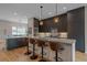 Modern kitchen with sleek cabinets, a marble backsplash, and a large island with seating at 726 Dreamcatcher Ln, Evergreen, CO 80439