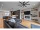 Stylish living area showcases a modern fireplace, custom bookshelves, and hardwood floors connecting to a gourmet kitchen at 726 Dreamcatcher Ln, Evergreen, CO 80439