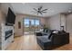 Bright living room with hardwood floors, cozy fireplace, and a large sectional sofa, with access to an outdoor balcony at 726 Dreamcatcher Ln, Evergreen, CO 80439
