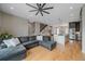 Spacious living room showcases hardwood floors, stylish fan, and open layout to staircase and kitchen at 726 Dreamcatcher Ln, Evergreen, CO 80439