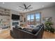 Cozy living room features a fireplace, built-in bookshelves, a large sectional couch and access to balcony at 726 Dreamcatcher Ln, Evergreen, CO 80439