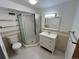 White tiled bathroom including a glass shower and sink with drawers at 1155 Ash St # 202, Denver, CO 80220
