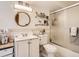 Traditional bathroom with a shower, a sink with vanity and a mirror with shelving at 1155 Ash St # 202, Denver, CO 80220