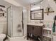Compact bathroom features shower stall, sink and vanity with storage space at 1155 Ash St # 202, Denver, CO 80220