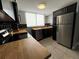 Modern kitchen features stainless steel appliances, sleek black backsplash, and butcher block countertops at 1155 Ash St # 202, Denver, CO 80220