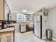 Modern kitchen with stainless steel appliances, dark cabinets, and a bright window offering natural light at 1155 Ash St # 202, Denver, CO 80220