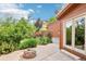Lush backyard with green foliage and trees surrounding a brick fire pit, ideal for outdoor enjoyment at 108 Ward Ct, Lakewood, CO 80228