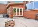 Spacious backyard patio with brick fire pit and glass-enclosed extension, perfect for outdoor relaxation at 108 Ward Ct, Lakewood, CO 80228