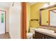 Cozy bathroom featuring vanity with sink, and a toilet, conveniently located near the entry for guests at 108 Ward Ct, Lakewood, CO 80228