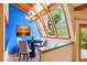 Bright dining room featuring large windows with wood trim, a modern chandelier, and sleek hardwood floors at 108 Ward Ct, Lakewood, CO 80228