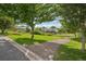 Community greenspace featuring a grassy area and a pathway leading to a residential area with mature trees at 108 Ward Ct, Lakewood, CO 80228