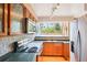 Well-lit kitchen featuring wood cabinets, modern appliances, granite countertops, and decorative backsplash at 108 Ward Ct, Lakewood, CO 80228