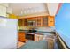 Well-lit kitchen featuring stainless steel appliances, granite countertops, and wood cabinets with glass panels at 108 Ward Ct, Lakewood, CO 80228