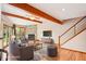 Inviting living room with hardwood floors, vaulted ceilings with exposed beams, and a stone fireplace at 108 Ward Ct, Lakewood, CO 80228