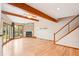 Spacious living area with wooden beams, a fireplace, and natural light, creating a warm and inviting atmosphere at 108 Ward Ct, Lakewood, CO 80228