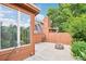 Open patio featuring a small brick fire pit with lawn care tools and a privacy fence in the background at 108 Ward Ct, Lakewood, CO 80228