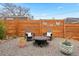 Outdoor patio area with stylish seating around a fire pit, complete with decorative accents and gravel at 1805 W 51St Ave, Denver, CO 80221