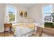 Inviting bedroom featuring hardwood floors, a wooden desk, and natural light through two large windows at 1805 W 51St Ave, Denver, CO 80221